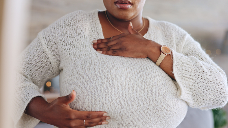 Breast cancer, self exam and black woman with hands on chest for testing, health check and detection. Healthcare, medical care and girl feel, touch and press breasts for awareness, symptoms or signs