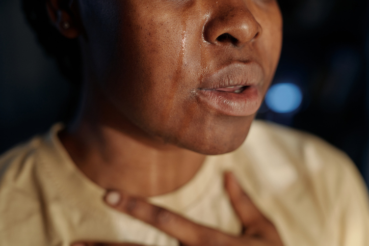 Part of face of young crying woman