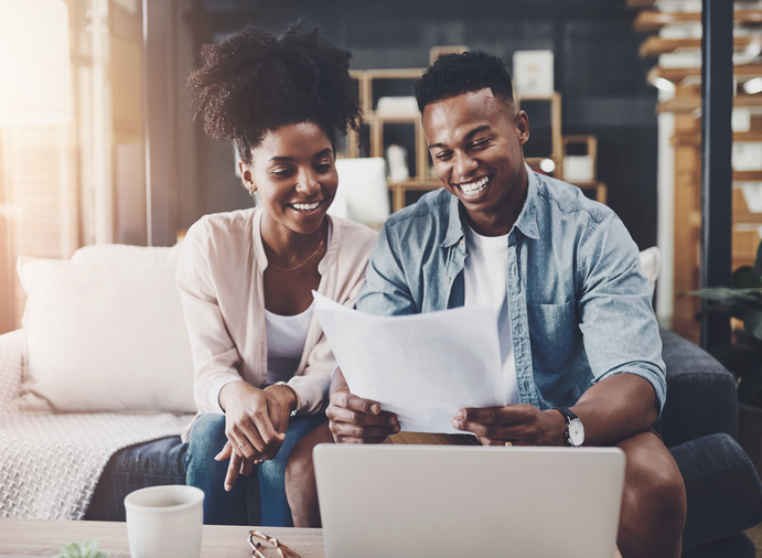 Finance, laptop and couple with paperwork on sofa for bills, life insurance or mortgage. Lens flare, documents and black man with woman on computer for planning budget, payment or investment in home