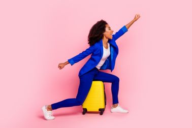 Photo of adorable crazy charming girl wear stylish blue clothes raise fist isolated on pink color background