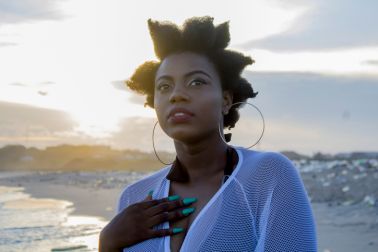 Woman Looking Away At Beach Against Sky