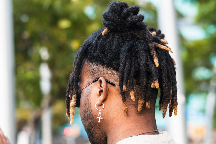 Modern guy with dreadlocks and in accessories
