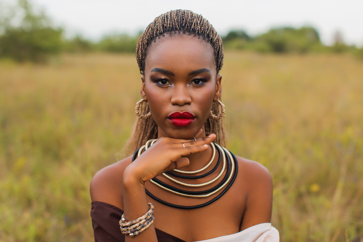 Beautiful woman in dress on background of nature. Authentic style. Stylish accessories. Fashion style.