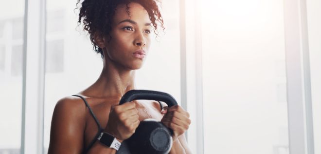 African woman, kettlebell and training at gym with thinking for workout, wellness and muscle development. Person, bodybuilder and weightlifting for change, exercise or body transformation with health