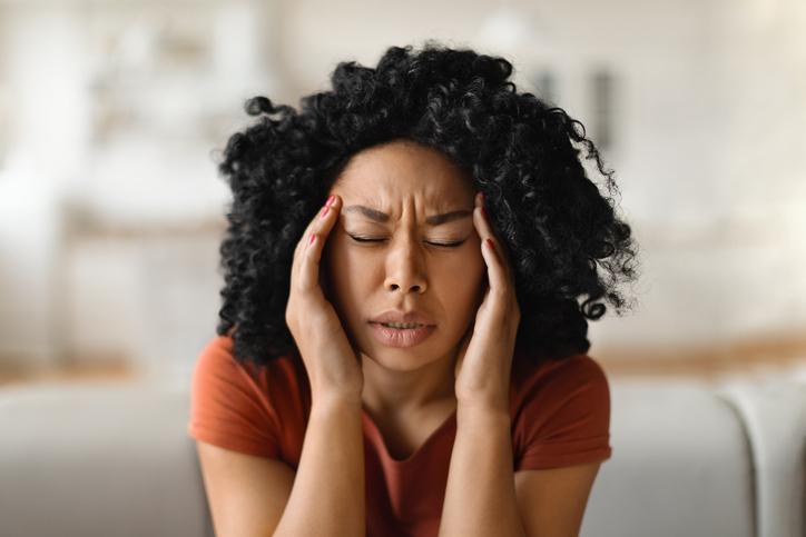 Migraine Concept. Closeup Shot Of Stressed Black Woman Touching Head With Hands
