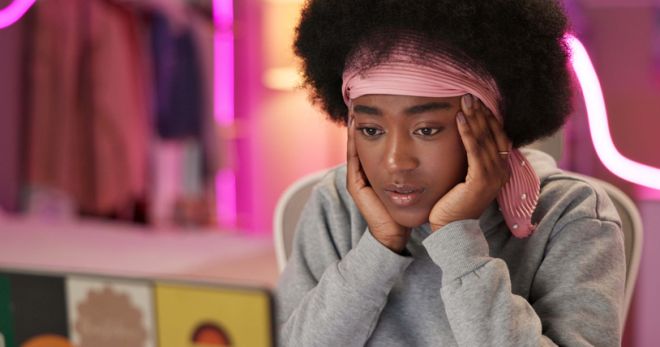 Black girl, laptop and thinking in home for college, online course and research project with stress at night. Student, technology and anxiety by study for university, education and idea with learning