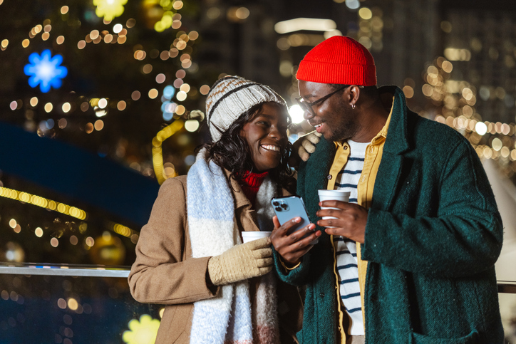 Happy couple enjoying winter holiday at night in the city