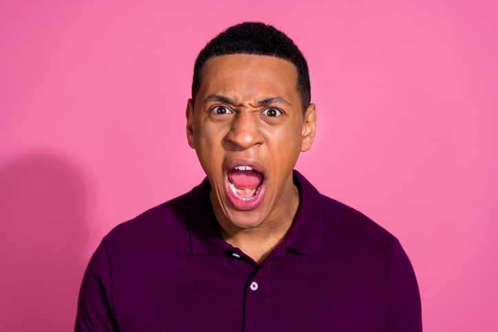 Photo portrait of handsome young guy angry screaming wear trendy violet outfit isolated on pink color background