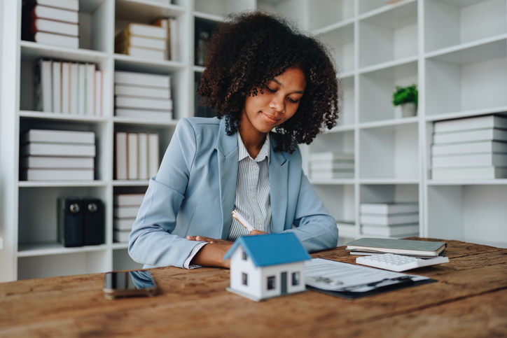 Guarantee, Mortgage, agreement, contract, Signing,woman african american client holding pen to reading agreement document to sign land loan with real estate agent or bank officer, insurance concepts
