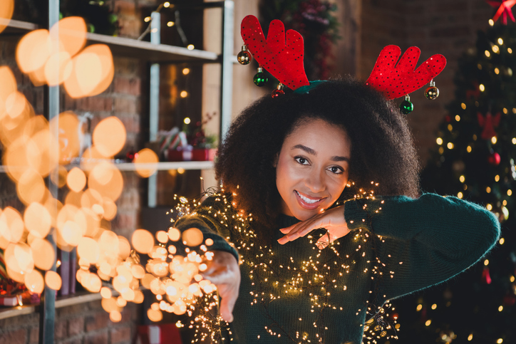 Photo of adorable pretty cute girl wear green sweater enjoy xmas weekend have fun new year party magic indoors home room
