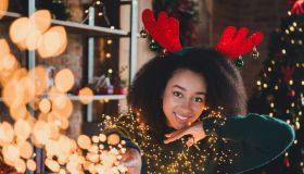 Photo of adorable pretty cute girl wear green sweater enjoy xmas weekend have fun new year party magic indoors home room