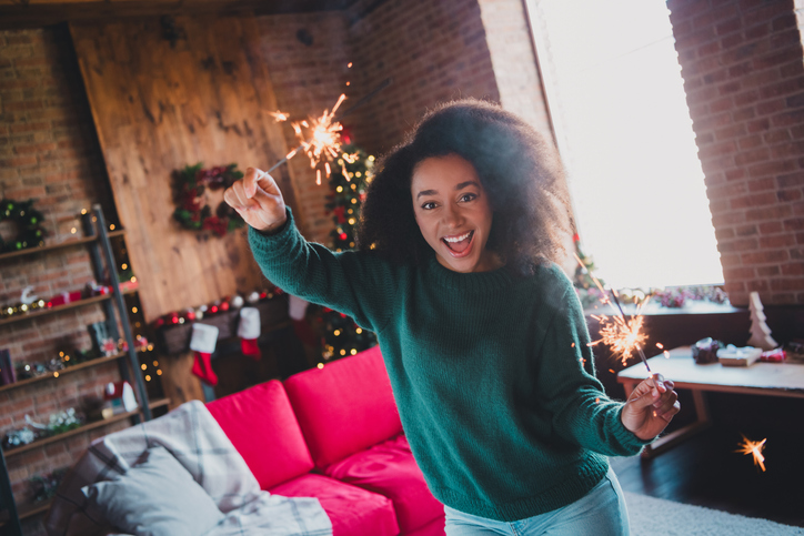 Photo of pretty young woman have good mood bengal lights wear sweater christmas festive time apartment indoors