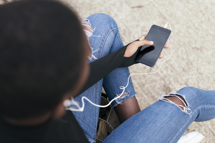 black woman listening to music with a mobile phone