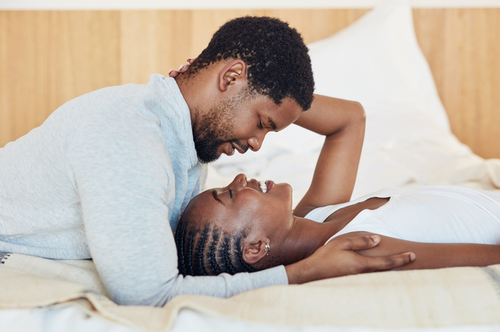 Shot of a young couple being intimate in bed at home