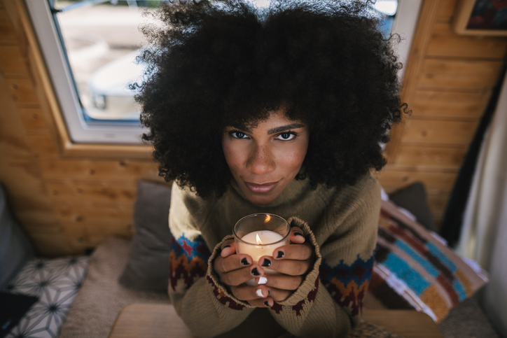 Afro girl holding a candle at Christmas time