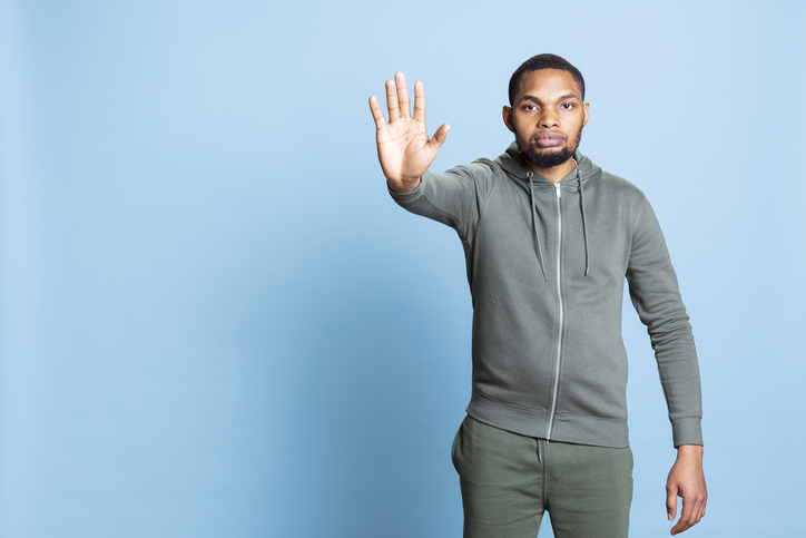 Confident african american person showing no symbol with his palm