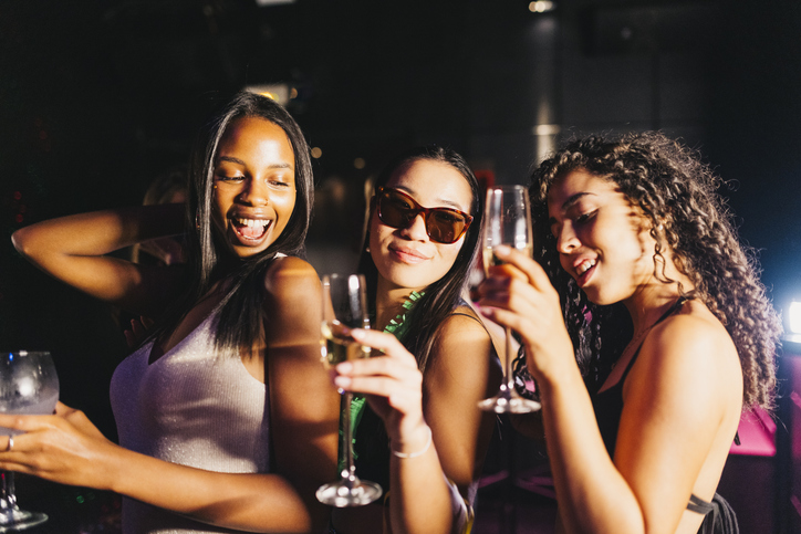 Joyful party celebration with friends dancing and enjoying drinks