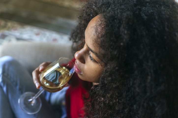 Portrait of woman drinking white wine