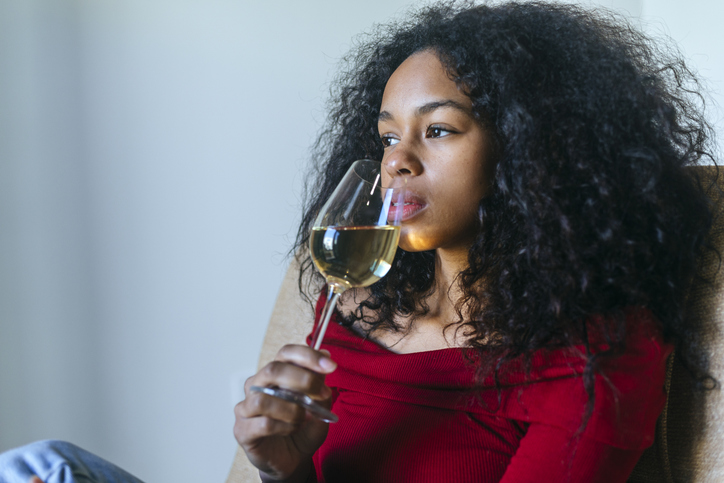 Portrait of woman drinking white wine