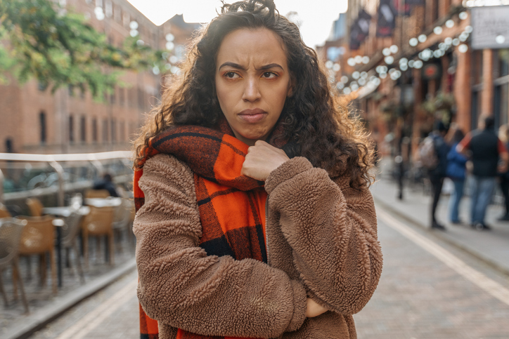 Disappointed Woman Wearing Plaid Scarf On Cold City Street