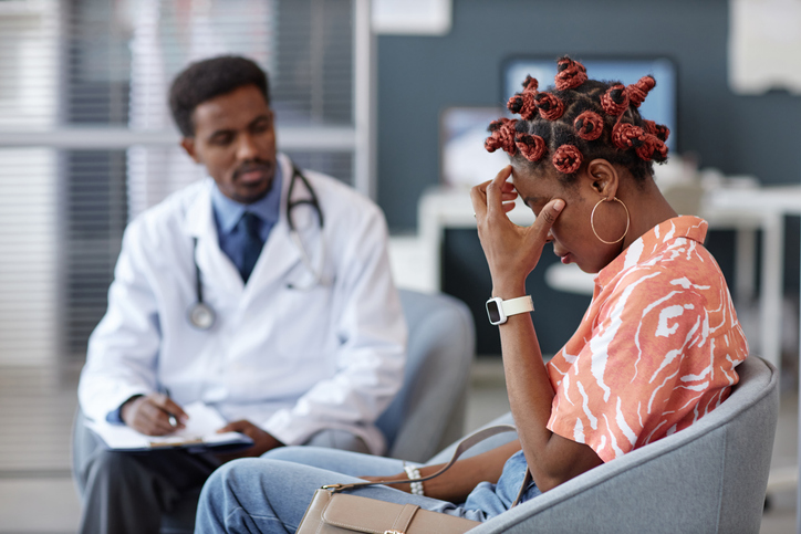 Frustrated Black Woman Rubbing Eyes After Getting Bad News at Doctors Office