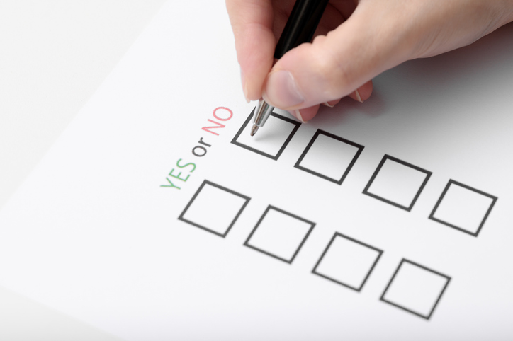 A woman fills out a survey with yes or no answers