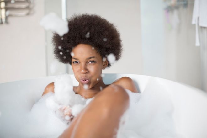 Woman playing with bubbles in bath