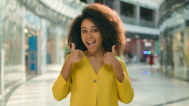 African American woman show thumb up approval yes agreement ok good female excited girl gesturing enjoy great satisfaction smile cool recommendation like advice hand sign shopping mall buyer customer