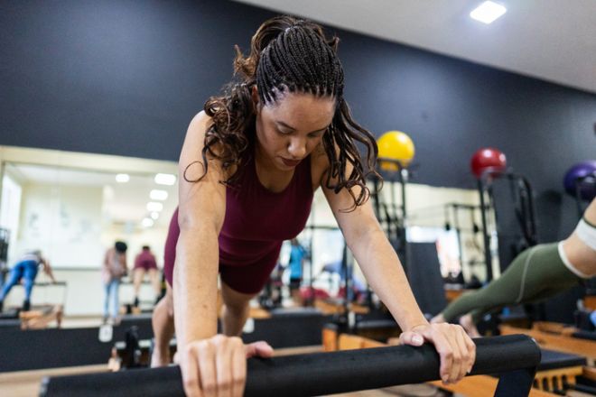 Mid adult woman doing pilates on a health club