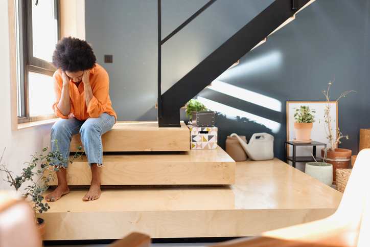 Stressed woman sitting at home