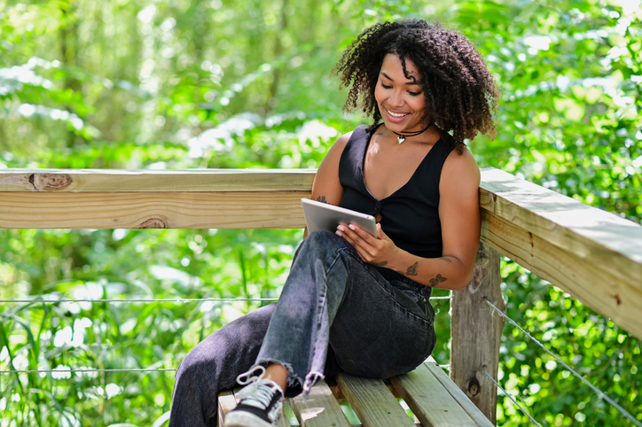 young woman with a snack of coffee and croissant
