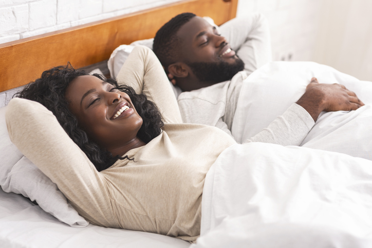 Young black couple relaxing in bed after make love