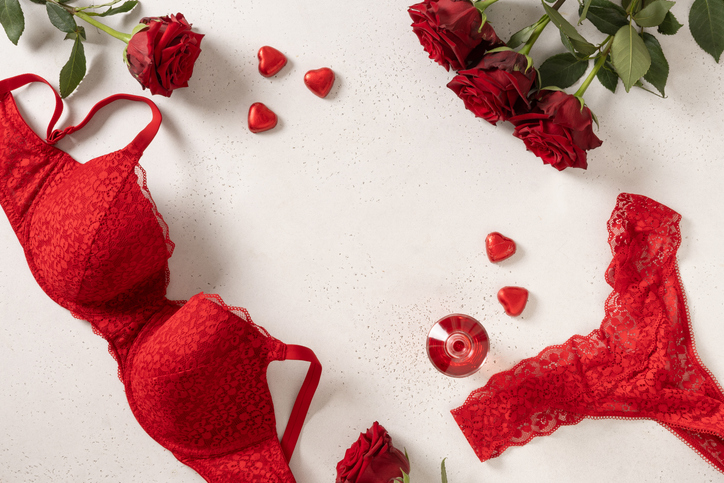 Valentine's day frame. Red lace bustier underwear, candy sweets and red roses