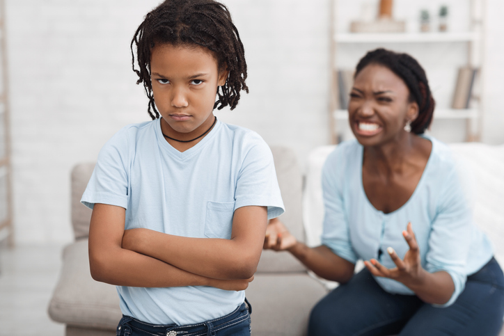 Angry black woman shouting at little girl