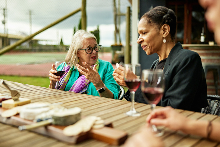 Senior women conversing during wine tasting event