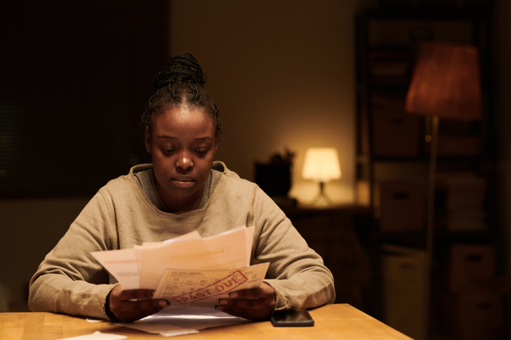 Young upset woman with past due bills