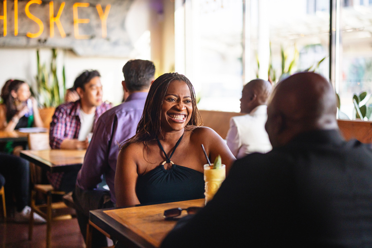 Mature Black Woman Enjoying a Date in Cozy Bar