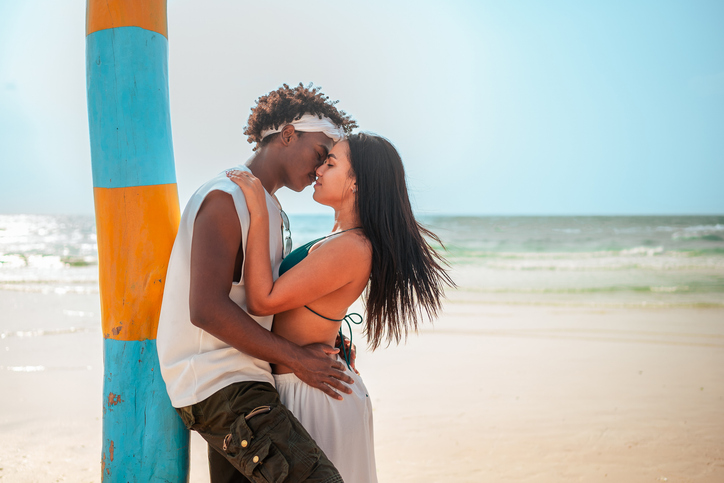 Romantic Beach Embrace by Diverse Couple