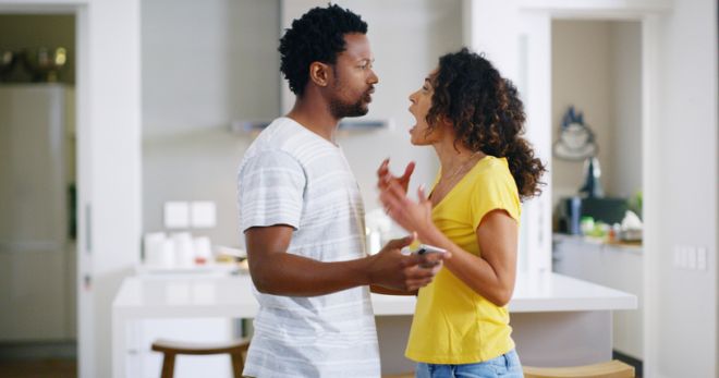 Couple, fight and angry as toxic relationship and scream as argument, disagreement and shouting in home. Woman, man and yell in lounge with marriage, unhappy and upset for conflict, mistake and trust