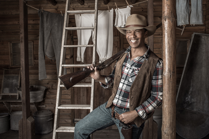 Handsome Black Cowboy in an authentic wild west setting