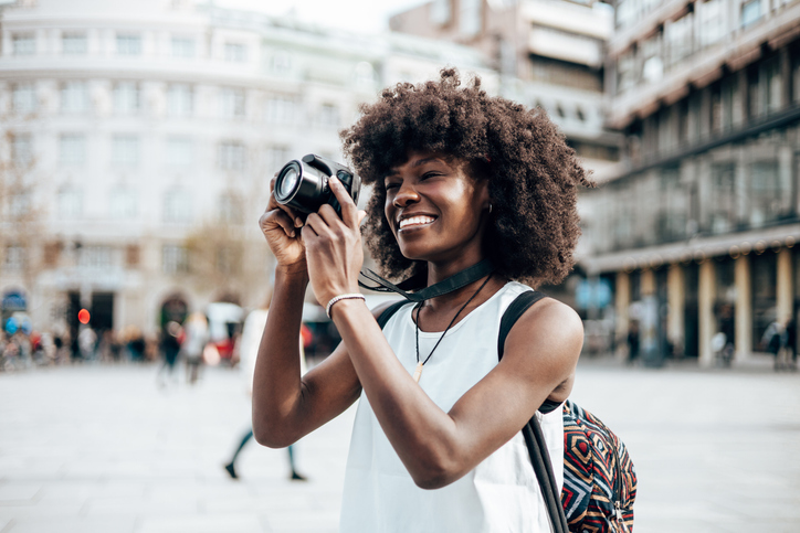 Black female tourist on city street