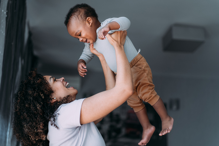Mother and cute baby boy having fun at home.