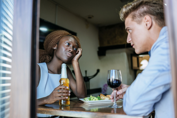 Couple having a difficult conversation at restaurant table