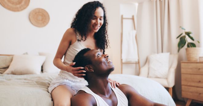 Break, morning or couple on bed for talking, resting or bonding in hotel or home on anniversary. Marriage, relax or man with woman in bedroom for relationship, commitment or chat on valentines day