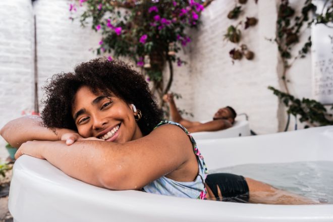 Portrait of a young woman in a bathtub at a spa