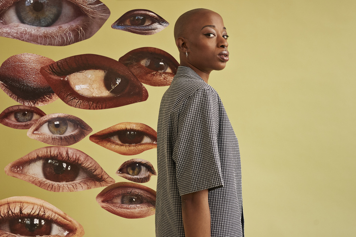 Non-binary person by eyes cut outs