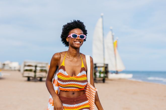 Young Black Woman Walking On The Beach In Spain