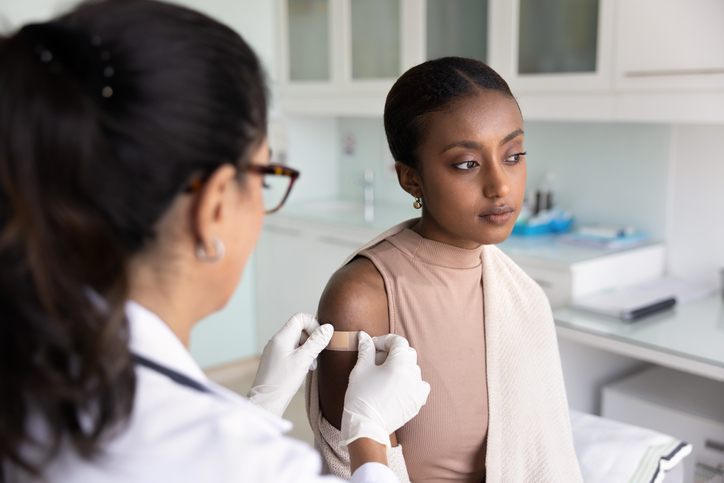 Serious depressed young Black woman visiting doctor for vaccination