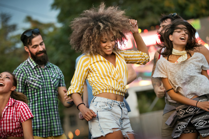 Friends dancing at a concert.
