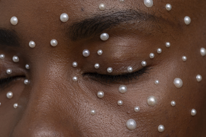 Close-up of woman wearing pearl freckles